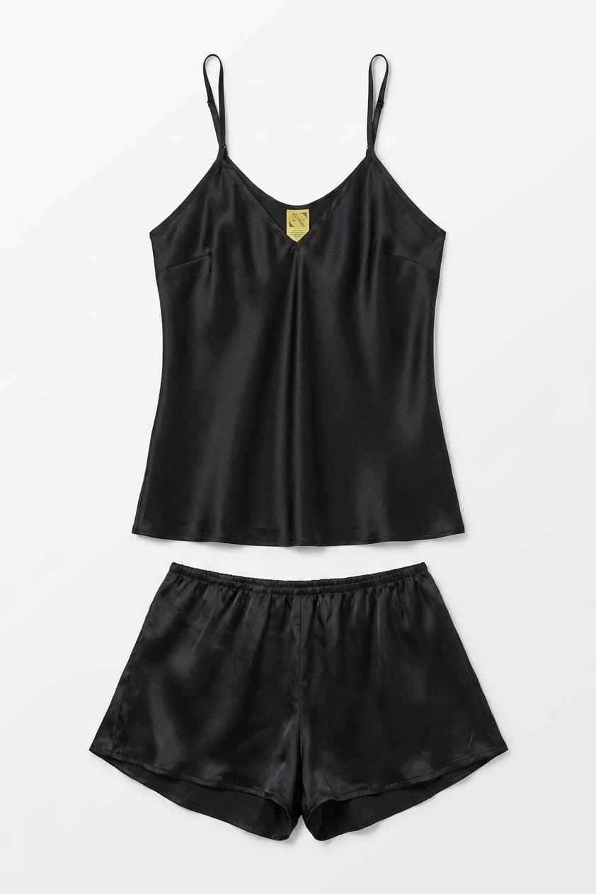 Black satin camisole and shorts set on a white background